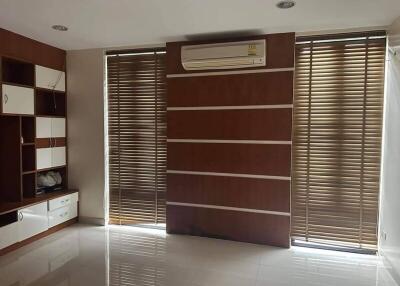 Spacious living room with modern wooden blinds and air conditioning
