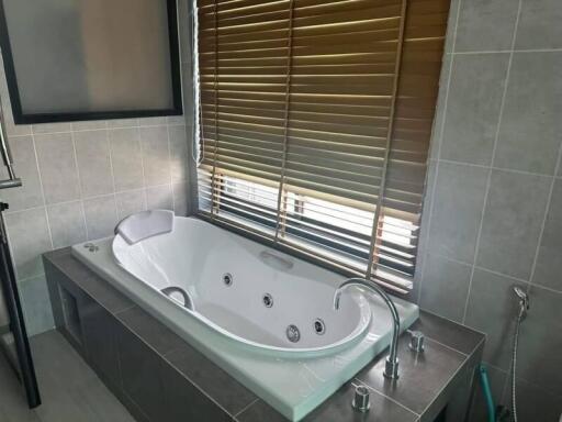 Modern bathroom with large soaking tub and window blinds