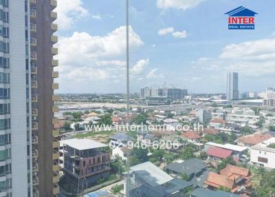 View of a cityscape from a high-rise building with residential and commercial areas