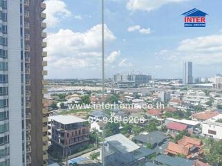 View of a cityscape from a high-rise building with residential and commercial areas