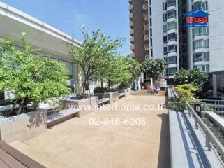 Spacious outdoor terrace with greenery and sitting area