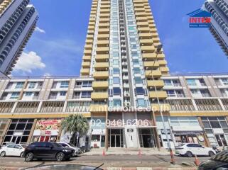 High-rise building façade with commercial spaces at the street level