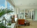 Modern living room with large windows and kitchen view