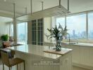 Modern kitchen with a large island, flowers, and city view