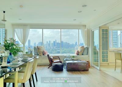 Spacious living room with large window and city skyline view