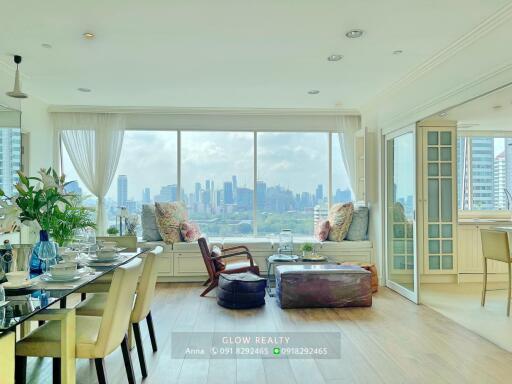 Spacious living room with large window and city skyline view