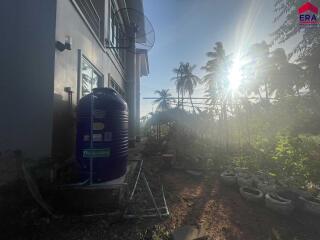 Backyard with garden and water tank