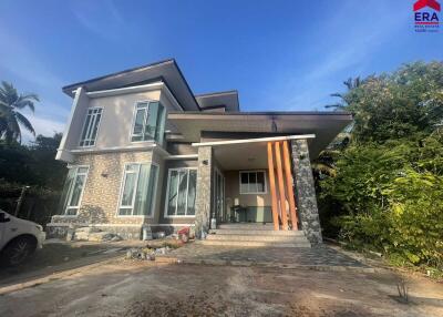 Modern two-story house with large windows and driveway