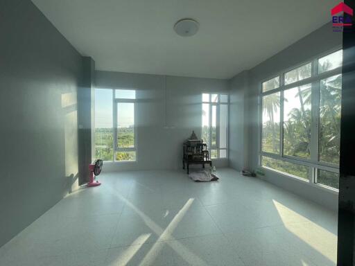 Spacious living area with large windows and ample natural light