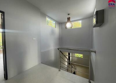 Staircase area with modern lighting and windows