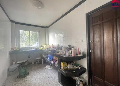 Kitchen with wooden door and shelves