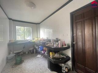 Kitchen with wooden door and shelves