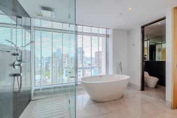 Stylish modern bathroom with glass shower and freestanding bathtub