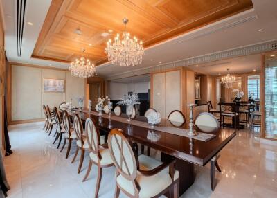 Elegant dining room with a long wooden table, chandelier lighting, and luxurious decor