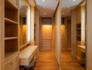 Spacious walk-in closet with built-in wooden shelves and vanity