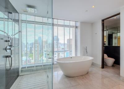 Modern bathroom with freestanding bathtub and city view