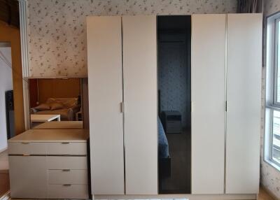 Spacious bedroom with large wardrobe and dresser