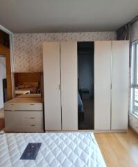 Spacious bedroom with large wardrobe and dresser