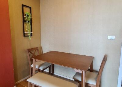 Dining area with table, chairs, and wall-mounted air conditioner