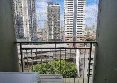 A balcony with a view of tall buildings