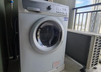 Laundry area with washing machine and outdoor AC unit