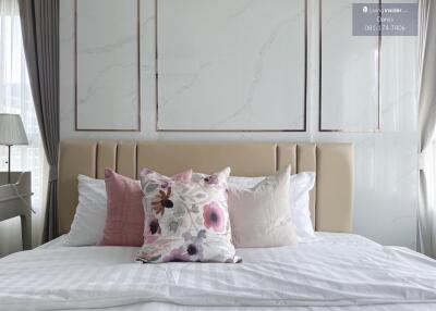 Master bedroom with elegant pillows and neutral-toned decor