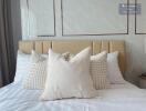 Modern bedroom with neatly arranged pillows on a bed