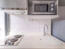 Modern kitchen with stove, sink, and microwave