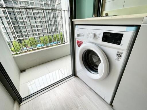 Balcony with washing machine and view of apartment buildings