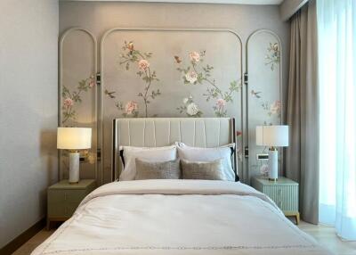 Elegant bedroom with decorative wall, bed, and bedside tables