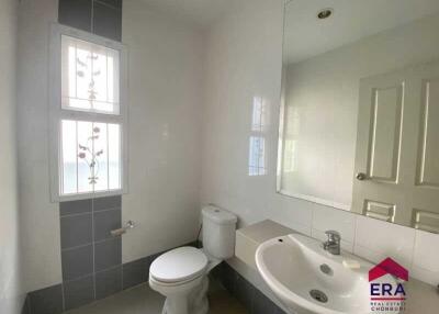 Bathroom with sink, toilet, and large mirror