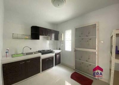 Modern kitchen with dark wood cabinetry and natural light