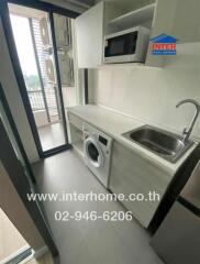 Compact kitchen with appliances and balcony view