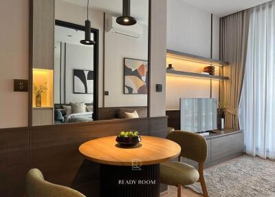Modern living room with contemporary decor, mirror accents, and cozy dining area