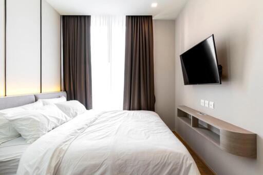 Modern bedroom with wall-mounted TV