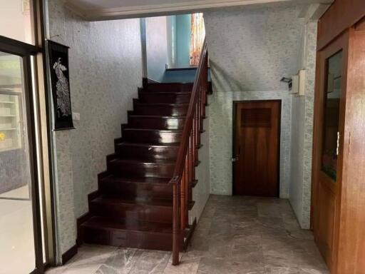 Photograph of a residential hallway with a staircase