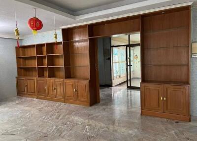 living room with built-in wooden shelves and cabinets