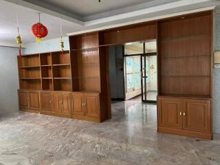 living room with built-in wooden shelves and cabinets