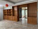 living room with built-in wooden shelves and cabinets