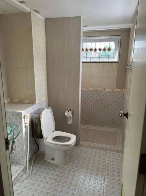 Modern bathroom with glass sink and tiled shower