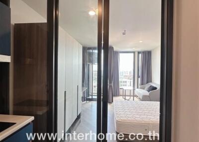 Bedroom with sliding glass doors and a large window