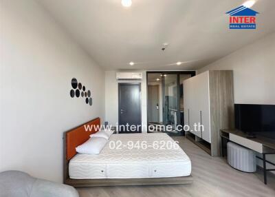 Modern bedroom with a bed, TV, wardrobe and air conditioner