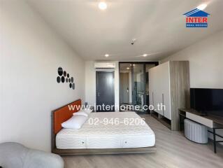 Modern bedroom with a bed, TV, wardrobe and air conditioner