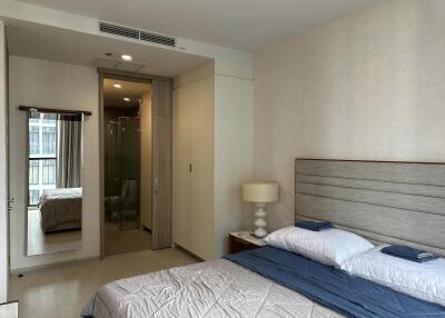 Modern bedroom with a large bed, wardrobe, and ensuite bathroom