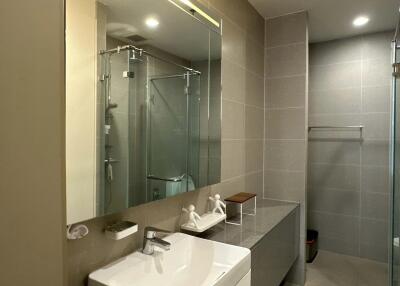 Modern bathroom with glass shower and large mirror