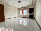 Spacious bedroom with tiled floor and large windows