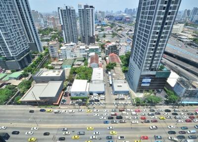 View of city from above with high-rise buildings and busy traffic