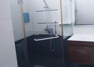 Modern bathroom with glass-enclosed shower and wall-mounted sink