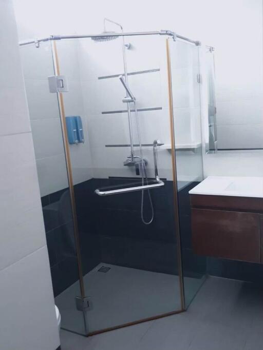 Modern bathroom with glass-enclosed shower and wall-mounted sink