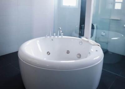 Modern bathroom with round bathtub and glass shower
